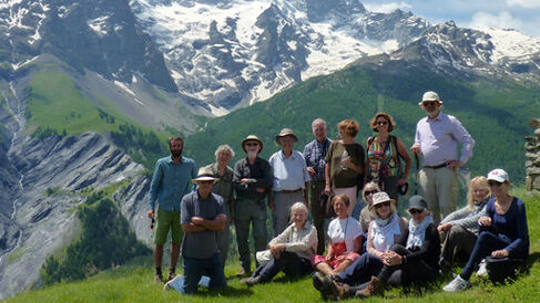 Group of adults on a hiking trip with mountains in the background
