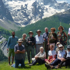 Group of adults on a hiking trip with mountains in the background