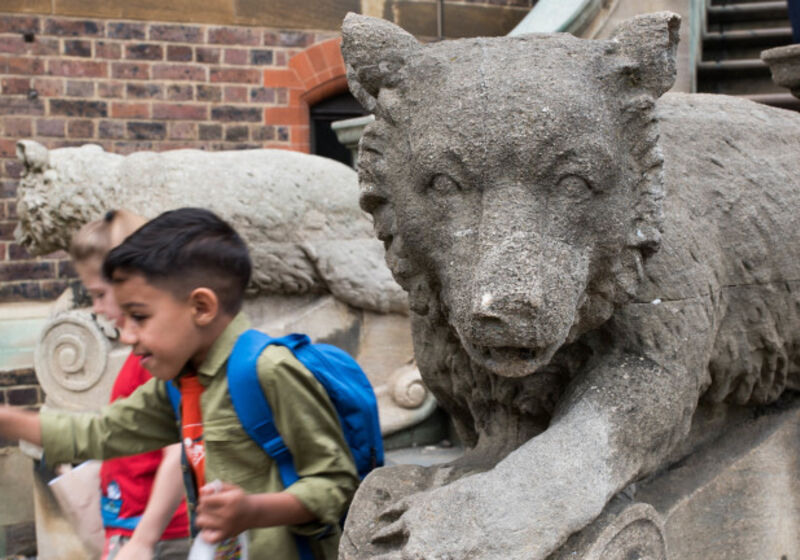 Children running down the Museum steps