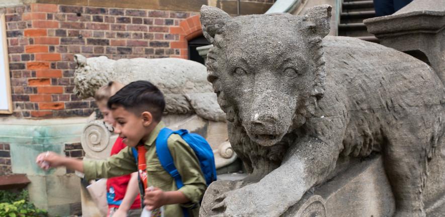 Children running down the Museum steps